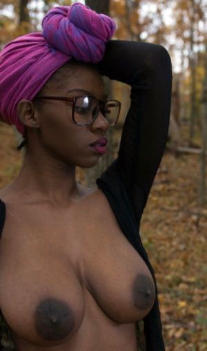 Tall ebony model with big nipples posing